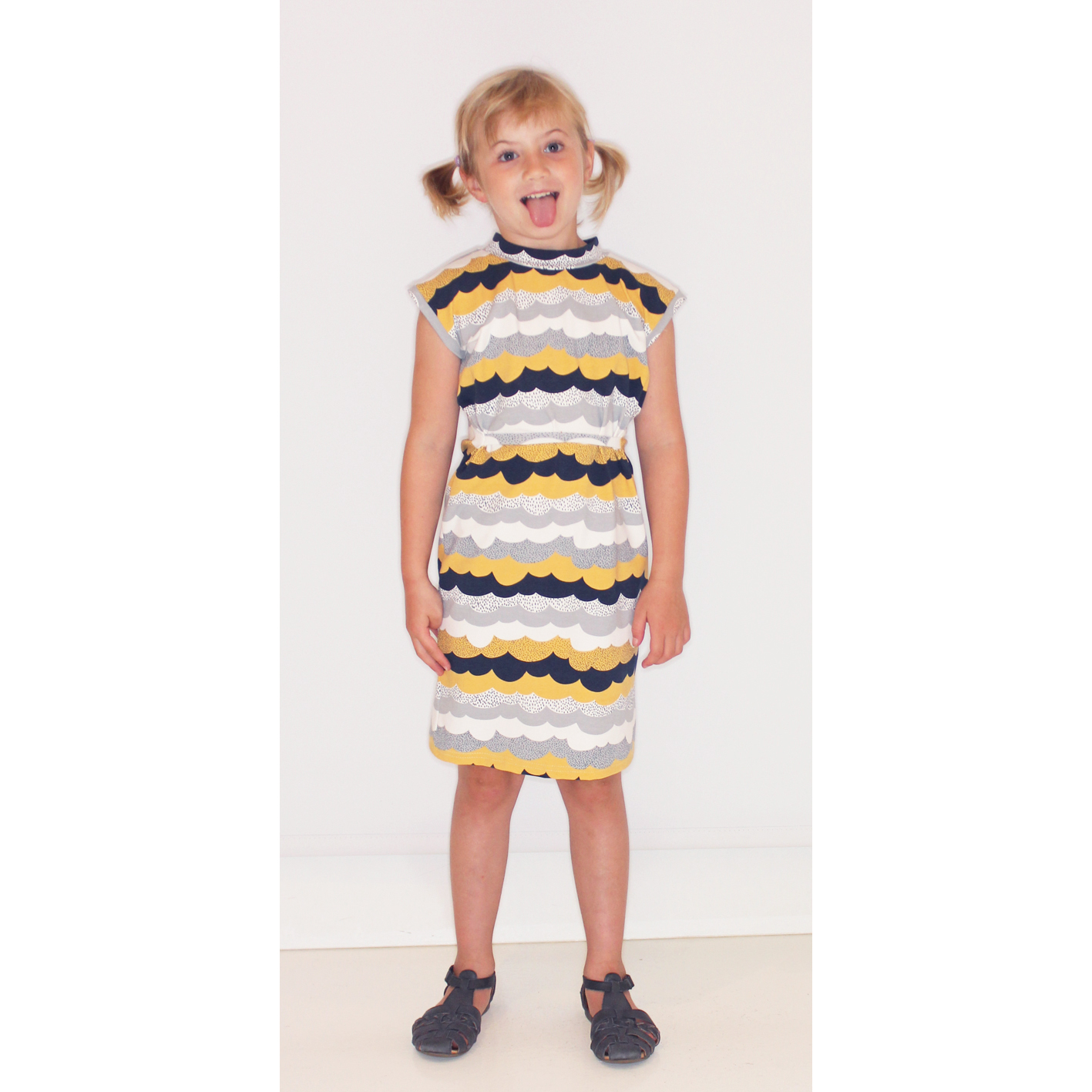 Draped cotton dress with yellow clouds print for kids.