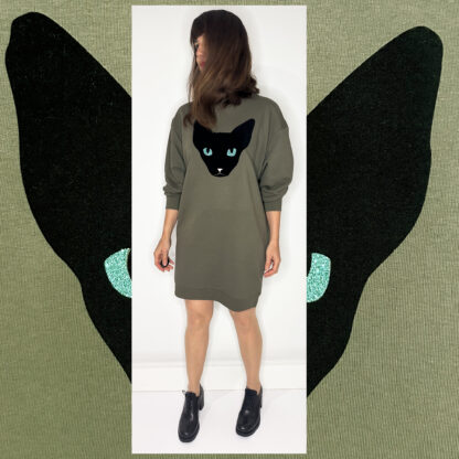Forest green long sweater featuring a unique cat print in black velvet foil with glittering green eyes, made from organic cotton and Fair Wear-certified, hand-printed in Amsterdam.