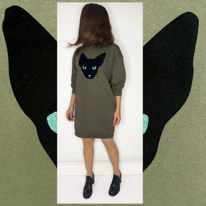 Forest green long sweater featuring a unique cat print in black velvet foil with glittering green eyes, made from organic cotton and Fair Wear-certified, hand-printed in Amsterdam.