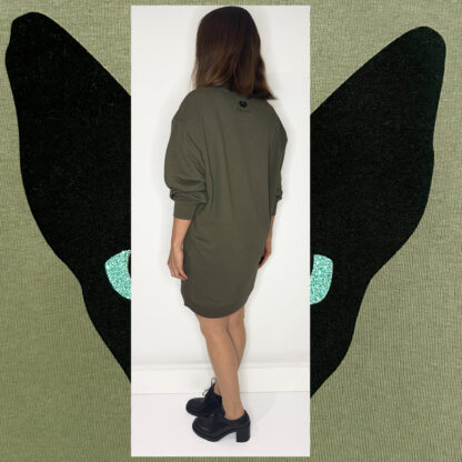 Forest green long sweater featuring a unique cat print in black velvet foil with glittering green eyes, made from organic cotton and Fair Wear-certified, hand-printed in Amsterdam.